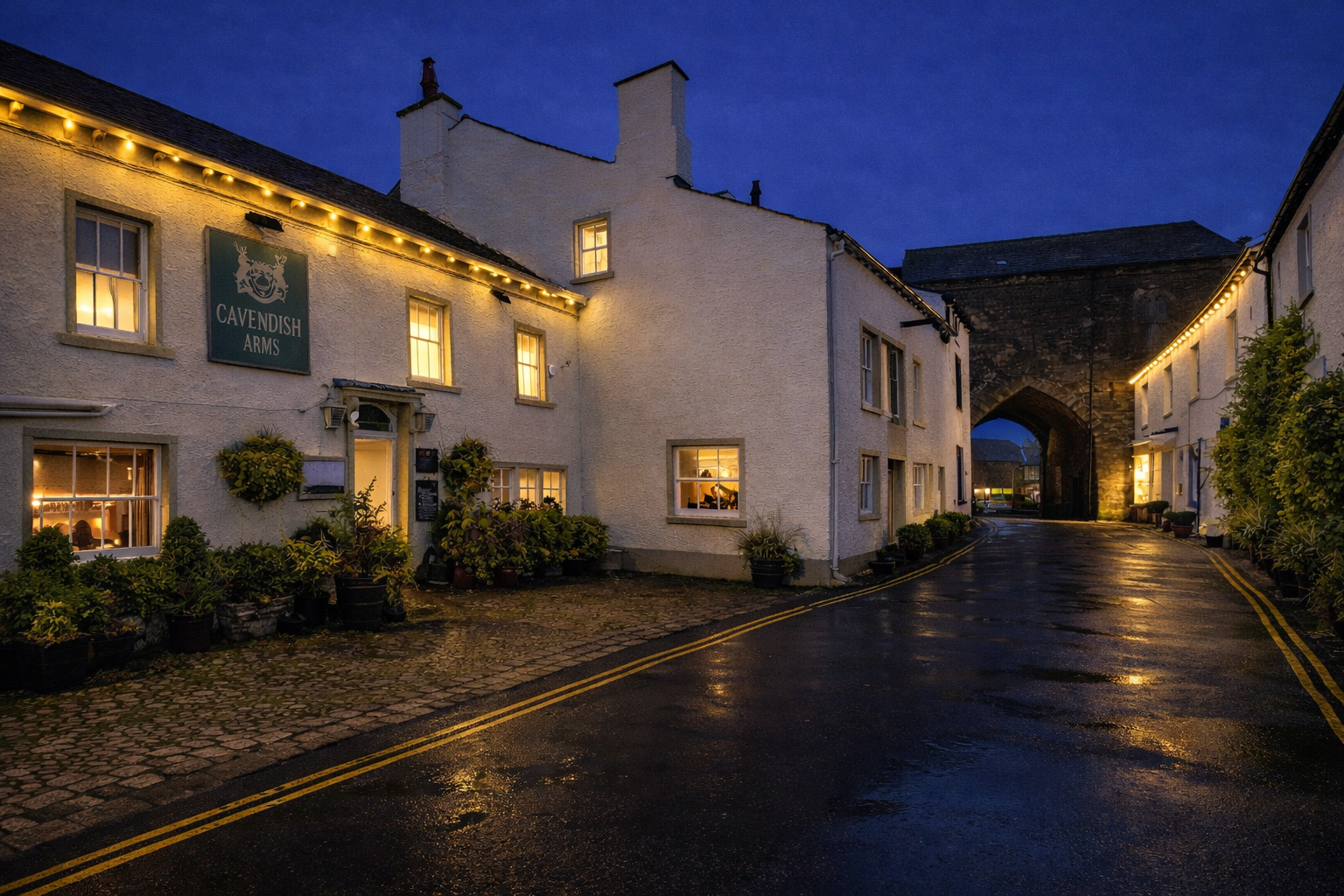 The Cavendish Arms historic exterior at night with warm glowing windows